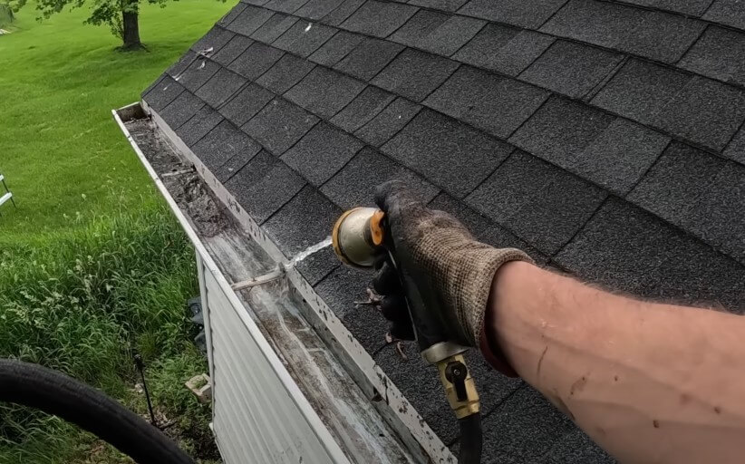 Water rinsing debris from a gutter