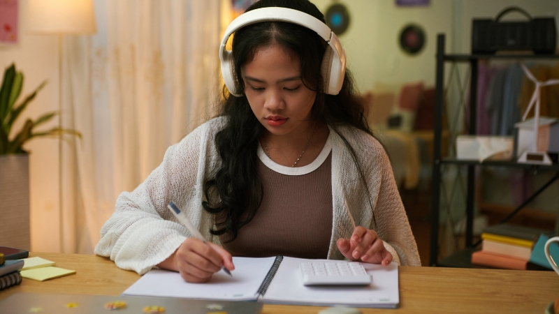 A student works through math and physics problems at a desk during a focused daily study session