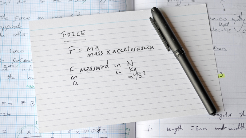 Handwritten notes show force equations and units, typical of problem setup in math and physics