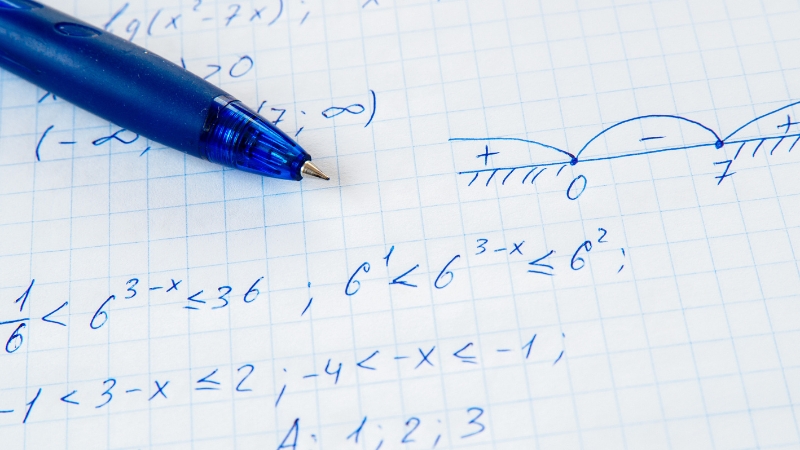Handwritten equations and sketches on graph paper, typical of retrieval practice in math and physics