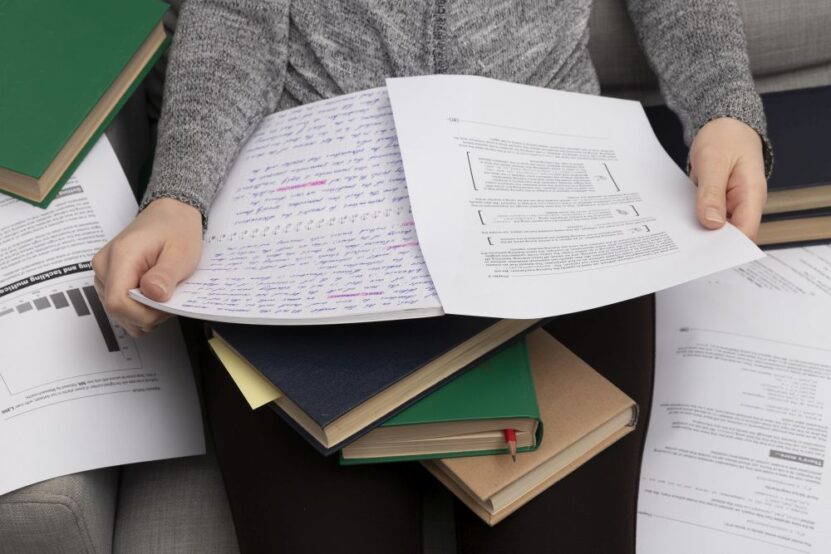 Student reviewing academic records and university test materials
