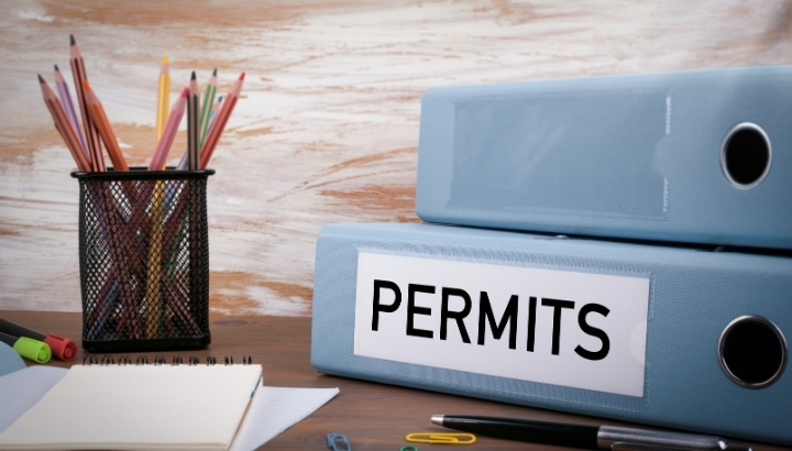 Building permit records stored in office binders for property review.